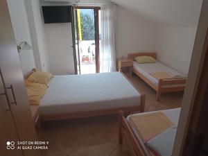 A bed or beds in a room at Apartments Petrović