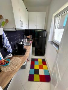 a kitchen with a colorful rug on the floor at BlackMintHouse in Rakovac