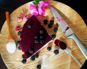 a cutting board with a knife and blackberries on it at La Masia de Montpedrós in Peralada +24 photos