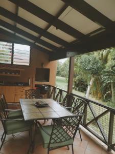 a wooden table and chairs on a balcony with a television at San Lameer Villa, Beach Estate, South Coast KZN in Marina Beach