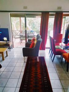 a living room with chairs and a couch and a table at San Lameer Villa, Beach Estate, South Coast KZN in Marina Beach