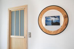 a mirror next to a door with a picture of the statue of liberty at Péribleu in Périgueux