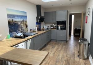 a kitchen with gray cabinets and a counter top at The Annexe - Pagham in Pagham