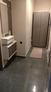 a bathroom with a sink and a mirror at Къща за гости Роял in Sandanski