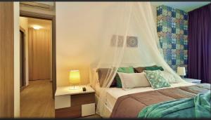 a bedroom with a bed with a mosquito net at Mediterraneo Apartments ARGENTO in Marzamemi +58 photos