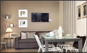 a living room with a table and a couch at Mediterraneo Apartments ARGENTO in Marzamemi