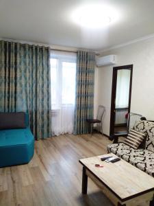 a living room with a couch and a table at Apartment on Svobody Square in Kherson