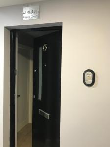 a hallway with a mirror and a door at Alison Court in Bristol
