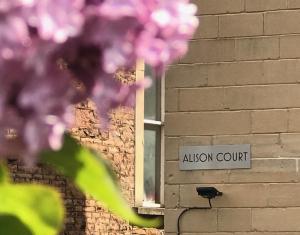 a street sign in front of a brick building at Alison Court in Bristol