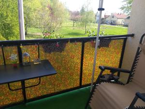 a balcony with a table and a view of a yard at Simon Apartman in Tiszafüred