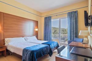 a hotel room with a bed and a balcony at Hotel Sant Jordi in Tarragona