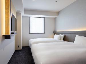 Cama ou camas em um quarto em Agora Tokyo Ginza
