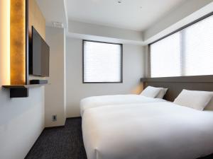 Cama ou camas em um quarto em Agora Tokyo Ginza
