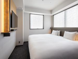 Cama ou camas em um quarto em Agora Tokyo Ginza