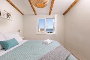 a bedroom with a bed and a window at Villa Liva in Vantačići +39 photos
