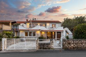 a house with a white fence in front of it at Villa Liva in Vantačići