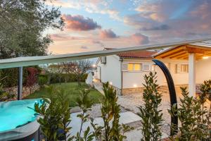 a view of a house from the backyard with a swimming pool at Villa Liva in Vantačići