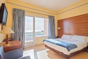 a hotel room with a bed and a window at Hotel Sant Jordi in Tarragona