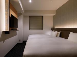 Cama ou camas em um quarto em Agora Tokyo Ginza