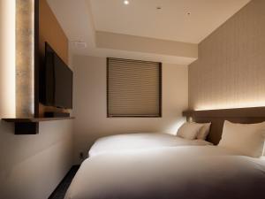 Cama ou camas em um quarto em Agora Tokyo Ginza