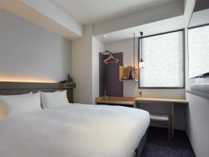 Cama ou camas em um quarto em Agora Tokyo Ginza