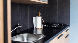 a kitchen counter with a sink and a stove at HuisjehurenEgmond in Egmond aan Zee