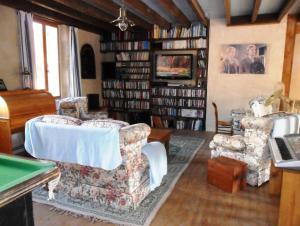 a living room with two chairs and a pool table at '1786' au bourg in Mansonville