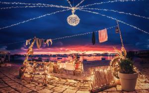 a view of a patio with christmas lights at night at Mediterraneo Apartments ARGENTO in Marzamemi