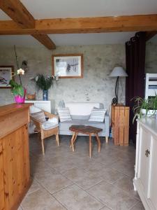 a living room with a couch and a table at Studio Les Chanterelles in Plan Motmin