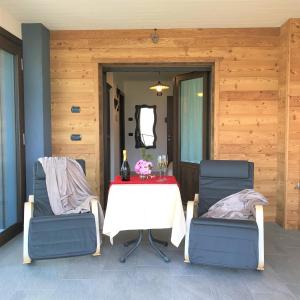 a table and two chairs with a table and a mirror at Affittacamere Verger Plein Soleil in Saint-Pierre