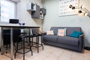 ein Wohnzimmer mit Sofa und Tisch in der Unterkunft Petit gite du Bistrot d ici in Saint-Saturnin