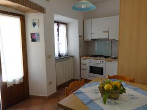 a kitchen with a table with a bowl of fruit on it at Turchese in Pomonte