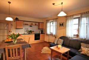 a living room with a couch and a table at Landhof Fischer in Geiersthal