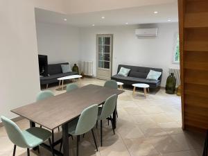 a living room with a wooden table and chairs at Camping la Paoute in Grasse