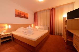 Postel nebo postele na pokoji v ubytování Strandhotel Faak