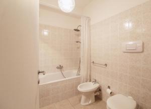 a bathroom with a toilet and a tub and a sink at Mimosa 24 in Acquaseria +13 photos