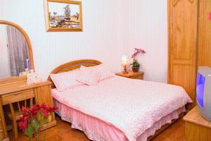 Posteľ alebo postele v izbe v ubytovaní Yilan Xiang Feng Homestay