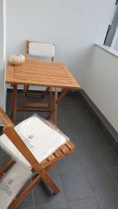 a wooden table and a chair next to a table and a table and chair at Hotel Eigelstein in Cologne