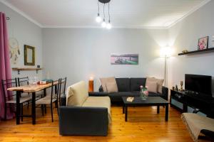a living room with a couch and a table at Akratos wine house in Nydri