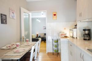 a kitchen and dining room with a table and chairs at Akratos wine house in Nydri +15 photos