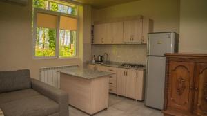 a kitchen with a couch and a refrigerator and a table at Shekvetili Big Wonder in Shekhvetili