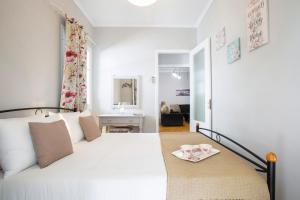 a bedroom with a white bed with a tray on it at Akratos wine house in Nydri