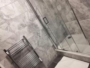 a shower in a bathroom with a glass door at Sherwood Hotel in Blackpool