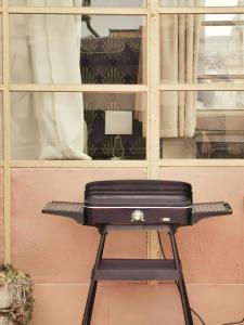 a black briefcase sitting on a stool in front of a window at Rumbach Terrace Apartment in Budapest