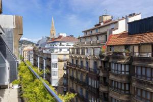 a view of a city with tall buildings at Aire de la Concha - The Rentals Collection in San Sebastián