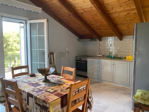 a kitchen with a table and chairs and a kitchen with a refrigerator at Thèros Mansion 5BR Mansion Sky Villa 360 Views, Infinity Pool & Jacuzzi Spa in Planos