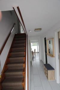 a hallway with a staircase in a house at Samlandhaus in Timmendorfer Strand