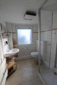 a bathroom with a toilet and a sink and a shower at Samlandhaus in Timmendorfer Strand