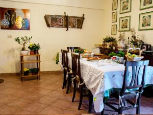 a dining room with a table with food on it at Bed And Breakfast Maria in Scopello
