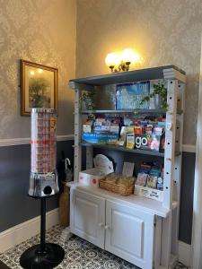 a white cabinet with food on it in a room at The Clovelly in Llandudno